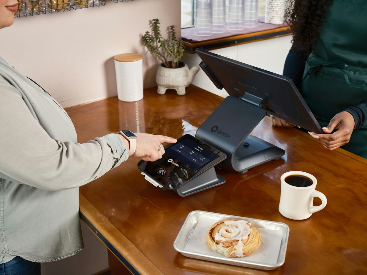 Customer paying by card at a cafe counter