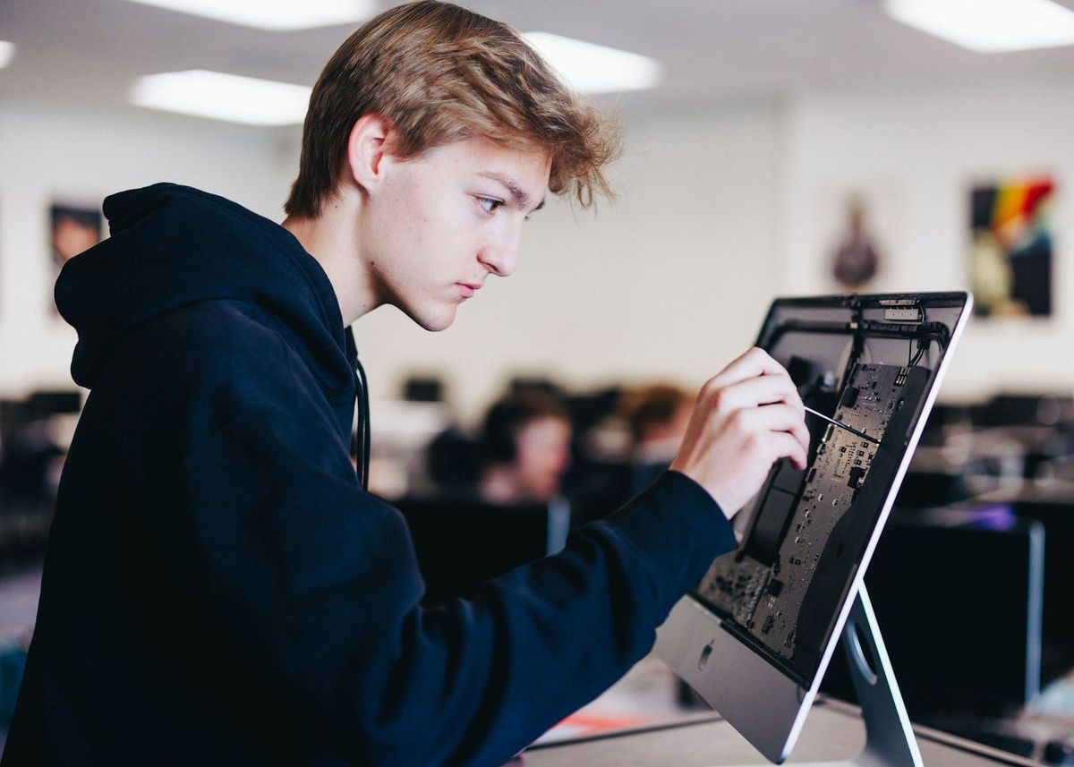 Student working on a touchscreen device in class