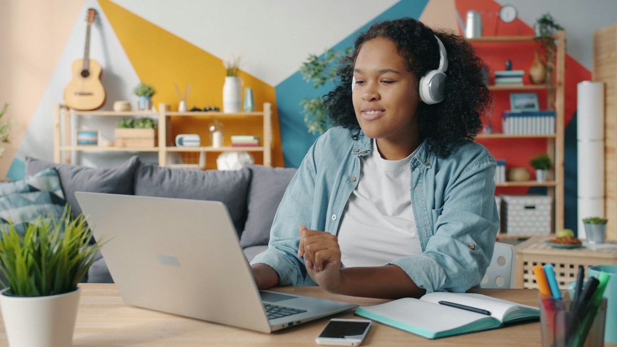 Student studying at home on a laptop